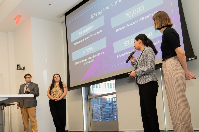 Luna Care, whose name is a celestial reference to charting new frontiers in women’s health, was one of five student teams competing Walter Dickey (at left), Kari Kochran, Nasrin Elahimehr, and Macy Parmelee present on postpartum hemorrhage.